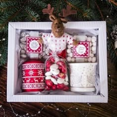 a christmas gift box filled with treats and decorations