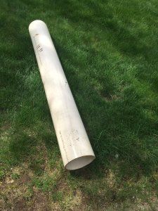 a white baseball bat laying on the ground