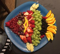 a blue plate topped with lots of fruit