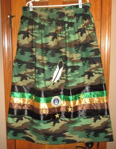 This is a Women's Ribbon Skirt. Camo with U.S. Air Force Veteran Patch and 5 gold stars and Feather Applique. Elastic waist that fits 36 to 42 inches includes 2 pockets. Length 32 1/2 inches. Homemade of 100% Cotton fabric in South Dakota. Feather Applique, Marine Corps Veteran, Marine Veteran, Air Force Veteran, Army Veteran