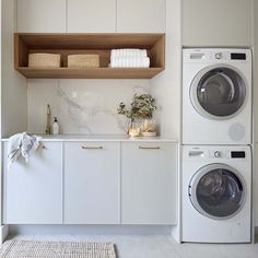 a washer and dryer in a white laundry room