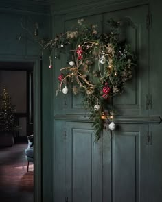 a wreath hanging on the front door of a house