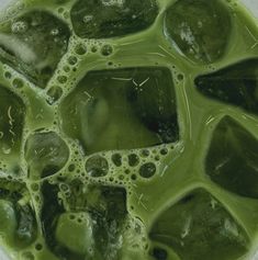 green liquid in a bowl filled with ice cubes