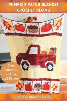 a crocheted blanket with a red truck and apples on it, sitting in front of a fireplace