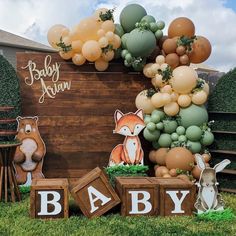 a baby shower is decorated with balloons and woodland animals