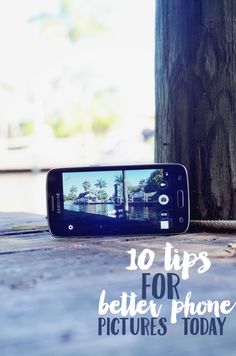 a cell phone sitting on the ground next to a tree with text overlay that reads 10 tips for better phone pictures today