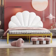 a bedroom with pink walls and furniture in the middle, including a bed frame that has a shell design on it