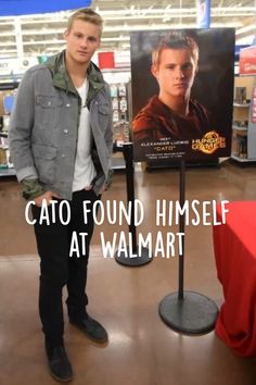 a man standing in front of a poster with the caption cato found himself at walmart