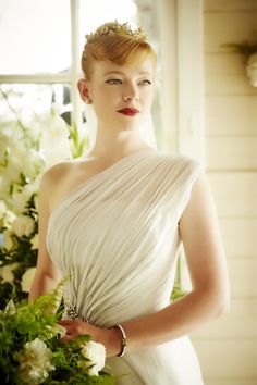 a woman in a white dress holding a bouquet