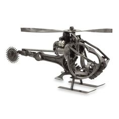 a metal model of a helicopter on a white background