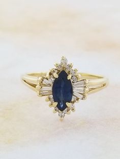 Sapphire and Diamond ring. Details: Size: US 5 1/2 ( Can be sized ) Weight: 2.8 grams Primary stone: Genuine Sapphire Shape: Marquise Secondary Stone: Diamond Shape: Round Metal: 14k Yellow Gold Condition: Previously worn/great condition Inside of band is stamped and tested for '14k' gold. All pieces are polished and refinished in our shop. SIZING: Currently this ring is a size 5 1/2 but could be sized up or down for an additional small fee if desired by adding custom ring sizing to your cart up Sapphire Accent Engagement Ring, Amethyst Studs, Future Engagement Rings, Knot Stud Earrings, Sapphire And Diamond Ring, Custom Ring, Initial Ring, Multi Stone Ring, Multi Stone