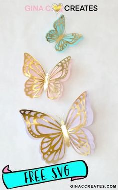 three gold and blue butterflies with the text free svg on it in front of them