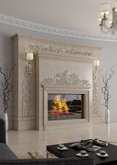 a living room filled with furniture and a fire place next to a wall mounted fireplace