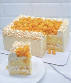 two pieces of cake with white frosting and orange toppings on each slice are sitting on plates