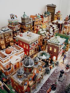 a christmas village is shown with people and buildings