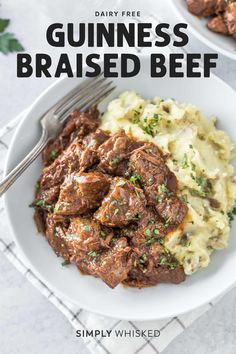 a bowl filled with beef and mashed potatoes on top of a white tablecloth