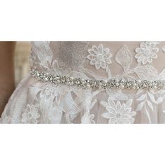 a woman wearing a wedding dress with beaded belt