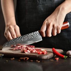 a person cutting meat with a large knife