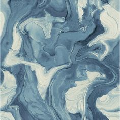 an abstract painting with blue and white paint on the surface, as seen from above