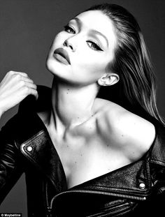 black and white photograph of a woman in leather jacket looking up at the sky with her hand on her shoulder