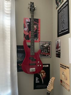 a red electric guitar hanging on the wall