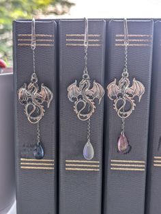 three bookends with dragon charms hanging from them