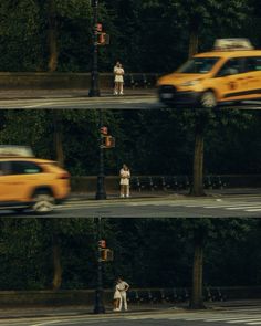 two people standing on the side of a road next to a traffic light and a yellow car