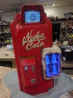 an old fashioned coke cola machine with blue lights on it's front and side