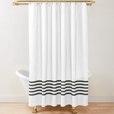 a shower curtain with black and white waves on the bottom, in front of a bathtub