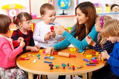 a group of children playing with toys at a table