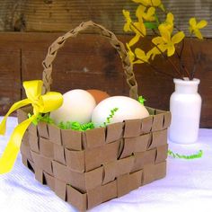 a basket filled with eggs sitting on top of a table