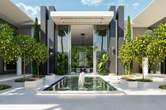 an outdoor fountain surrounded by trees and plants in front of a building with glass doors