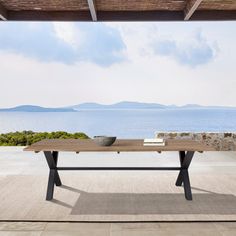 a wooden table sitting on top of a patio