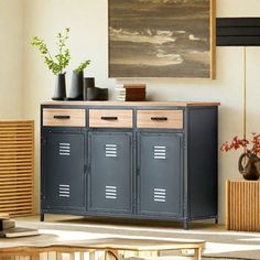 a living room with two metal lockers in front of a painting on the wall