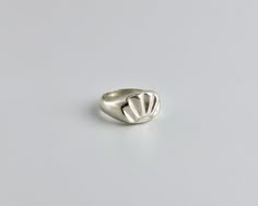 "Sterling silver woman's ring, hand carved with a design of a scallop shell.  Look down at your hand and be reminded of the reflective waters, the sun and the shells that line the ocean floor.  Hand carved from wax using the lost wax method and then cast in solid sterling silver.  Polished to a high shine.  Can be made in sizes 5 through 9, with half sizes. Signet measures 15mm wide 11 mm tall Love it but can't buy it right now? Click on the ❤️ to your right that says \"Add item to favorites.\" Gem Signet Ring, Wax Jewelry Carving, Lost Wax Ring, Wax Carving Ring, Lost Wax Casting Rings, Wax Carved Ring, Wax Carving Jewelry, Seashell Ring, Hand Carved Ring