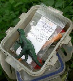 there is a plastic container filled with toys and writing on the label that says geocaching tips and tricks