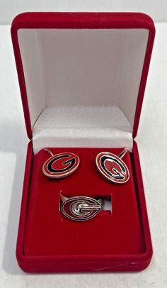 VINTAGE SET OF UNIVERSITY OF GEORGIA JEWELRY: EARRINGS + RING EARRING MEASURE APPROX. 3/4" WIDE X 1/2" TALL RING IS ADJUSTABLE ALL ITEMS ARE METAL SEE PICTURES THE ITEM PICTURED IS THE ONE YOU WILL RECEIVE - NO STOCK PHOTO’S ITEM WILL BE WELL PACKAGED AND SHIPPED WITH TRACKING WE LOOK FORWARD TO YOUR BUSINESS.  HAVE A GREAT DAY! Drawer 33/10 #6 Ring Earring, University Of Georgia, Watches Jewelry, Metal Jewelry, Have A Great Day, Ring Earrings, Georgia, Jewelry Earrings, University