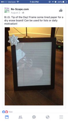 a photo frame with writing paper taped to the side and a bow at the top