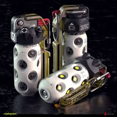 three different types of mechanical devices on a black surface with yellow eyes and red handles