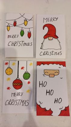 four christmas cards with santa's hats on them