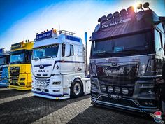 several semi trucks are parked in a row