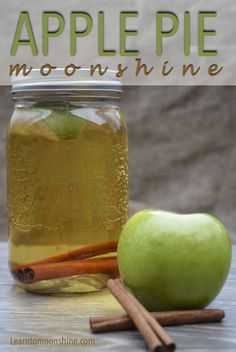 an apple and cinnamon stick sitting next to a mason jar filled with apples cider