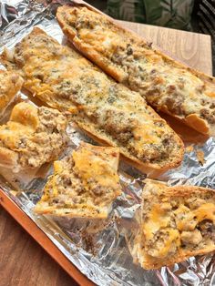 some food is sitting on top of tin foil and ready to be cooked in the oven