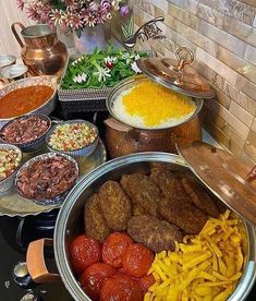 an assortment of food is displayed on a buffet table