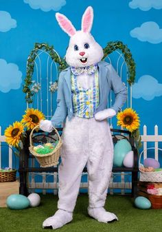 a man in bunny suit holding a basket with sunflowers