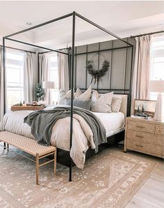 a bedroom with a four poster bed and pillows