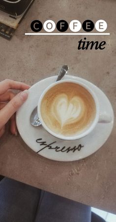 a cup of coffee with the words coffee time written on it and someone holding their hand