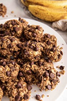 chocolate chip granola cookies on a plate next to bananas