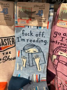 three pairs of socks that say, i'm reading the ghost book and have pictures on them