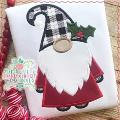 an applique christmas santa clause with holly on it